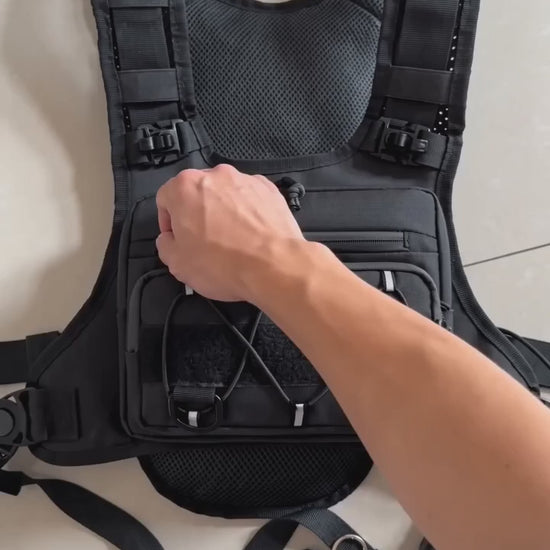 HydraKor hydration vest front pocket demo: phone, powerbank, keys and earbuds secured in one place