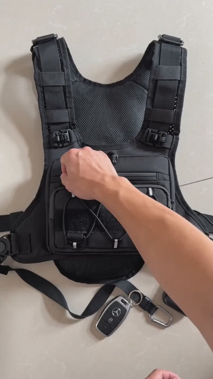 HydraKor hydration vest front pocket demo: phone, powerbank, keys and earbuds secured in one place