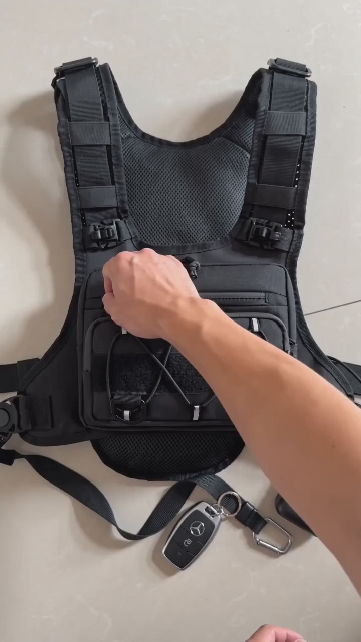 HydraKor hydration vest front pocket demo: phone, powerbank, keys and earbuds secured in one place
