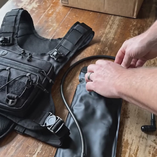 HydraKor 2L bladder demo: pour two bottles of water in, slide into the vest, hands free