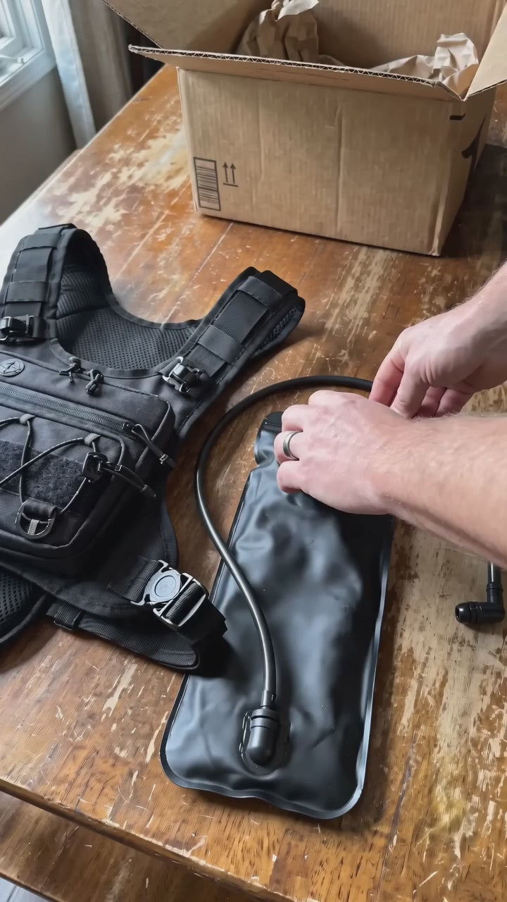 HydraKor 2L bladder demo: pour two bottles of water in, slide into the vest, hands free